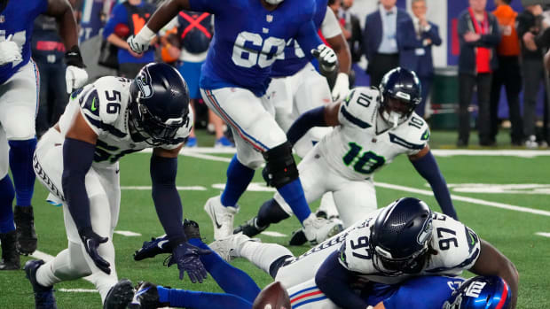 Oct 2, 2023; East Rutherford, New Jersey, USA; Seattle Seahawks linebacker Jordyn Brooks (56) picks up the loose ball after defensive end Mario Edwards Jr. (97) stripped the ball from New York Giants quarterback Daniel Jones (8) at MetLife Stadium. Mandatory Credit: Robert Deutsch-USA TODAY Sports